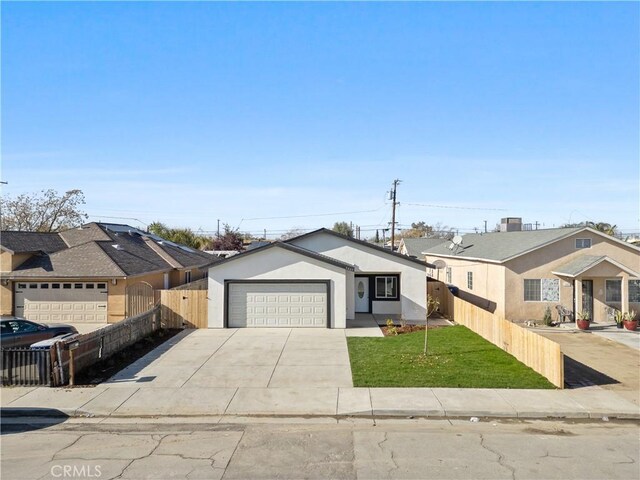 ranch-style home featuring a garage and a front lawn