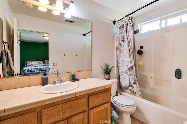 full bathroom with toilet, vanity, and shower / bathtub combination with curtain