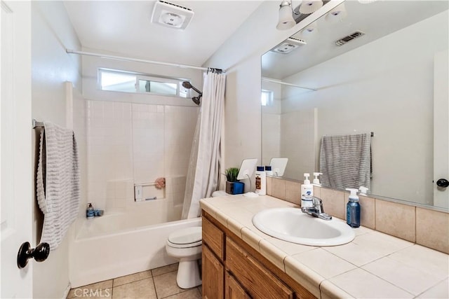 full bathroom with toilet, tile patterned floors, vanity, and shower / tub combo with curtain