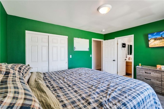 bedroom with a closet and ensuite bath