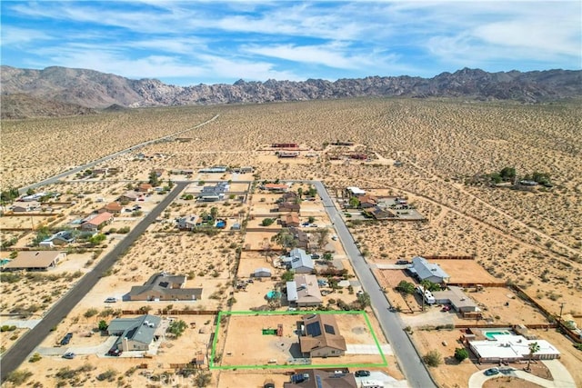 birds eye view of property with a mountain view