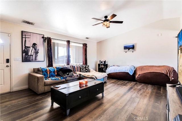 living room featuring ceiling fan, dark wood-type flooring, and lofted ceiling