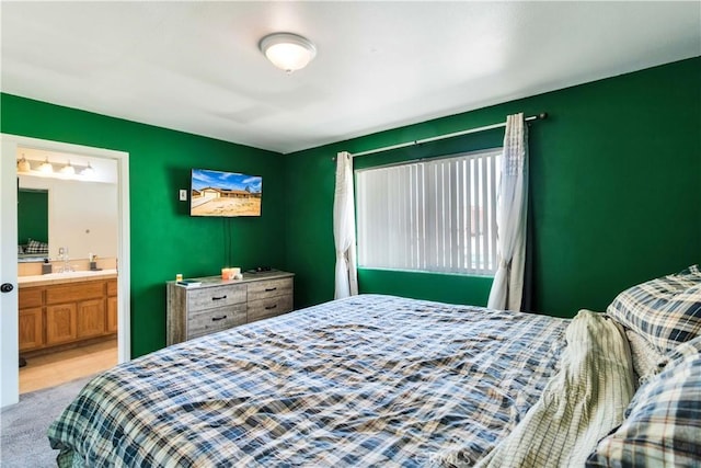 carpeted bedroom featuring ensuite bath