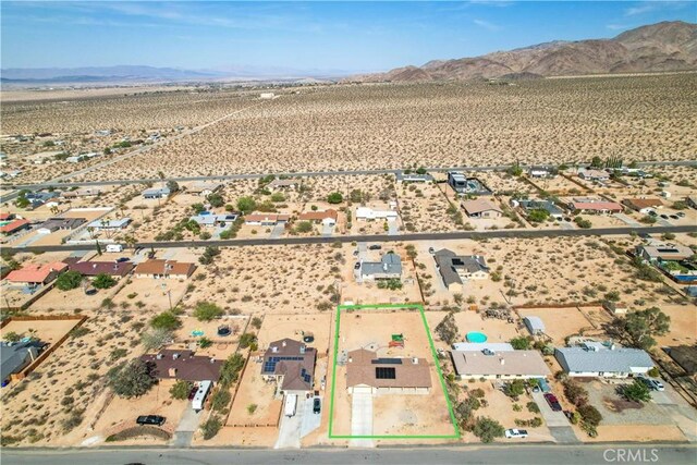 birds eye view of property featuring a mountain view