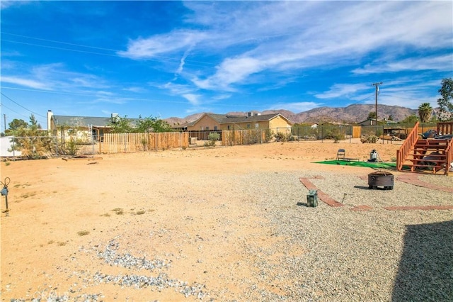 view of yard featuring a mountain view and an outdoor fire pit