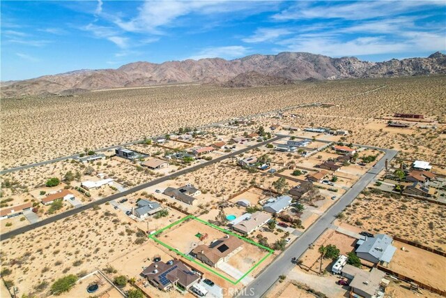 birds eye view of property featuring a mountain view