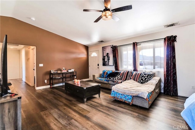 living room with ceiling fan, dark hardwood / wood-style flooring, and lofted ceiling