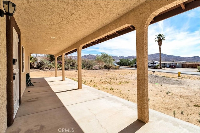 view of patio / terrace featuring a mountain view