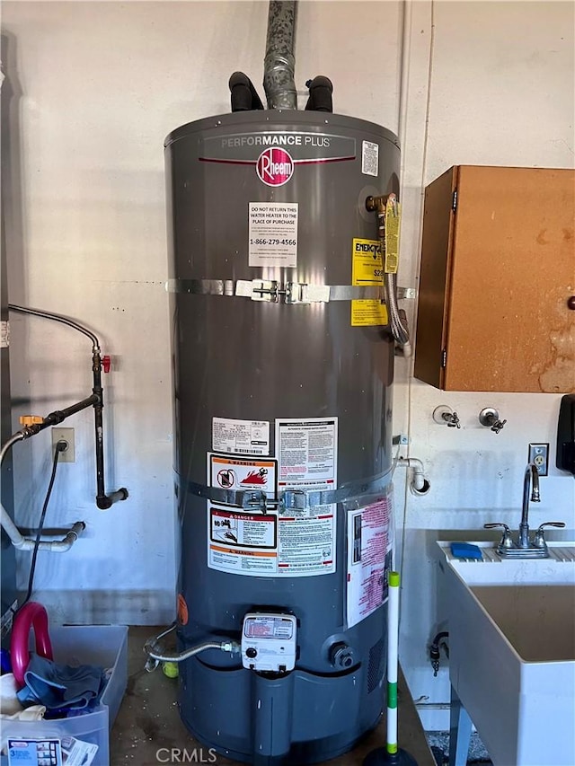 utility room with sink and strapped water heater