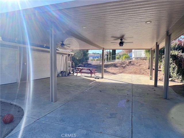 view of patio / terrace featuring ceiling fan and a garage