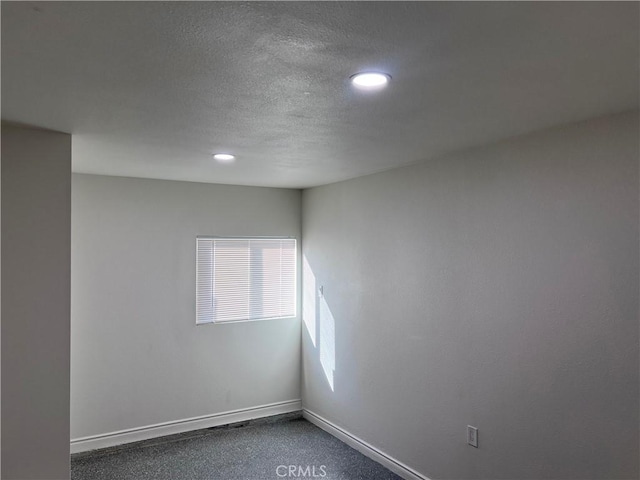 spare room with a textured ceiling