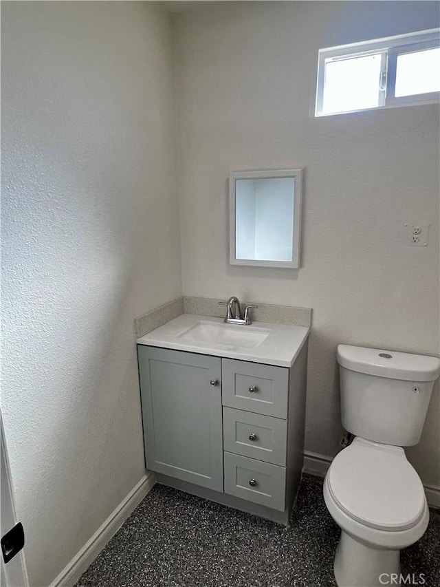 bathroom featuring toilet and vanity