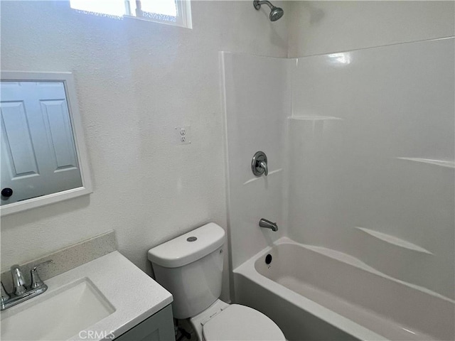 full bathroom featuring toilet, tub / shower combination, and vanity