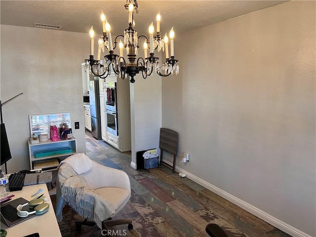 dining area with a textured ceiling and an inviting chandelier