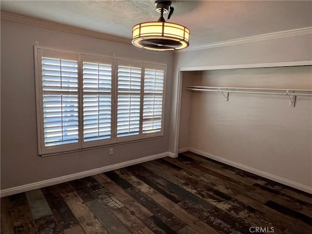 unfurnished bedroom featuring a closet, dark hardwood / wood-style flooring, and ornamental molding