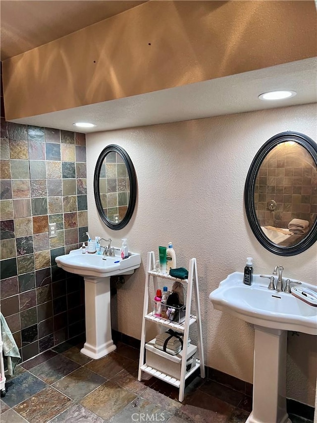 bathroom with sink and tile walls