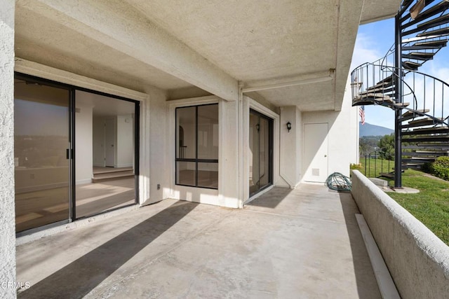 balcony featuring a patio area and a mountain view