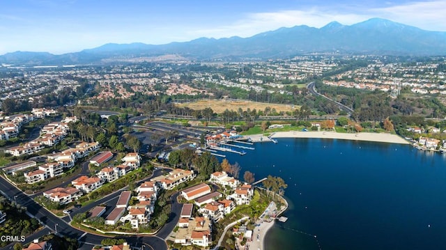 birds eye view of property with a water and mountain view