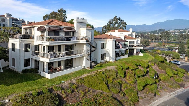 back of house with a mountain view