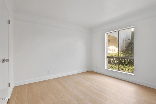 spare room with light hardwood / wood-style flooring and ornamental molding