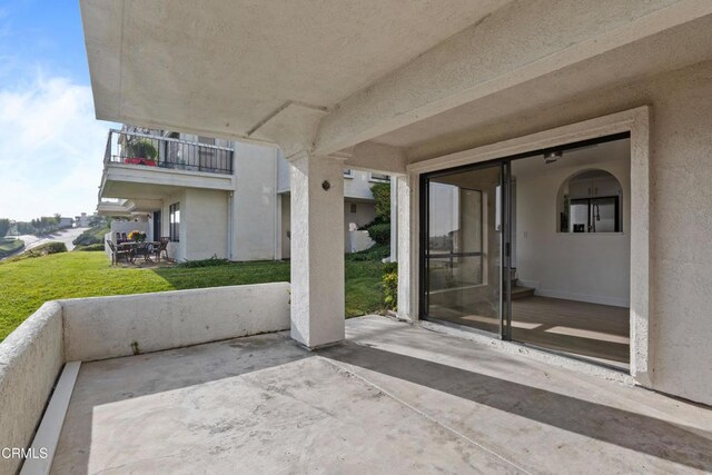 view of patio featuring a balcony