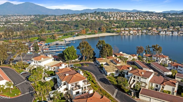 drone / aerial view with a water and mountain view