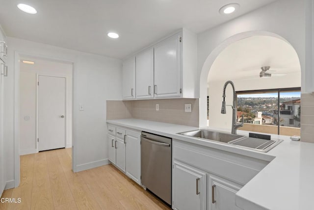 kitchen featuring decorative backsplash, white cabinetry, and dishwasher