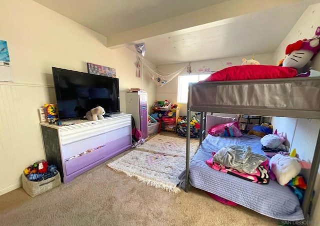 carpeted bedroom featuring beamed ceiling