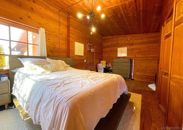 bedroom with wood walls and wooden ceiling