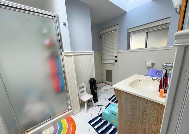 bathroom featuring vanity, tile patterned floors, and a shower with shower door