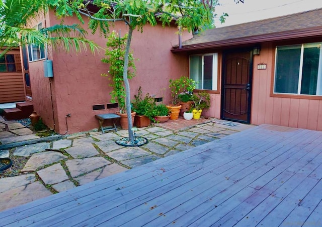 wooden terrace featuring a patio area