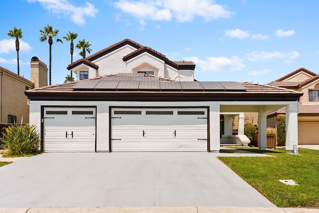 view of front of house with a front lawn, a garage, and solar panels