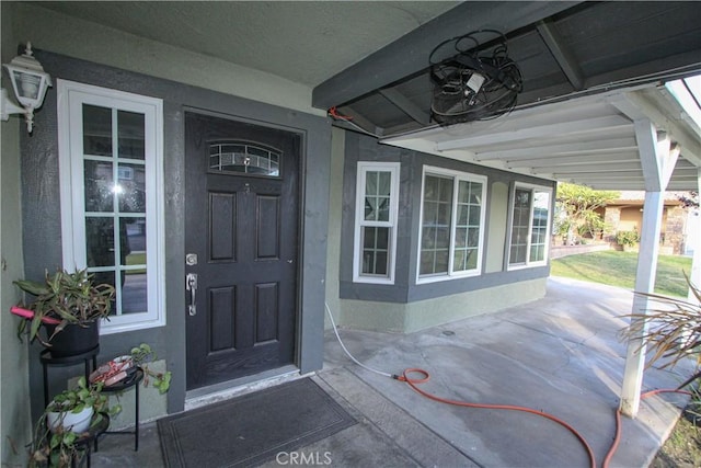 view of exterior entry featuring a porch