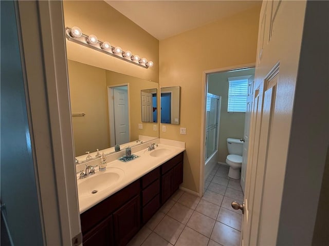 full bathroom featuring toilet, vanity, shower / bath combination with glass door, and tile patterned flooring