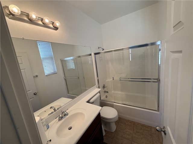 full bathroom featuring vanity, tile patterned floors, enclosed tub / shower combo, and toilet