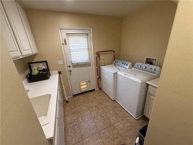 washroom featuring cabinets and independent washer and dryer