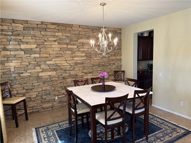 dining area with an inviting chandelier