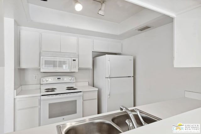 kitchen featuring white cabinetry, sink, track lighting, and white appliances