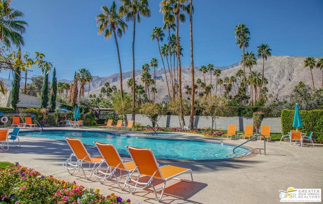 view of pool featuring a mountain view and a patio area