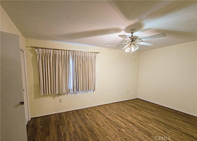 empty room with ceiling fan and dark hardwood / wood-style floors