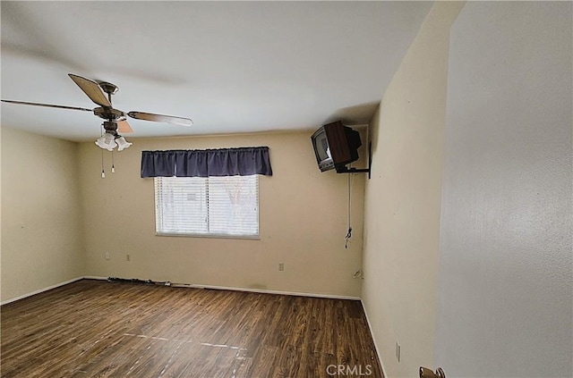 spare room with ceiling fan and dark hardwood / wood-style flooring