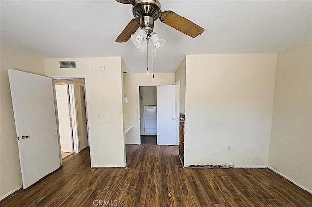 spare room with ceiling fan and dark wood-type flooring