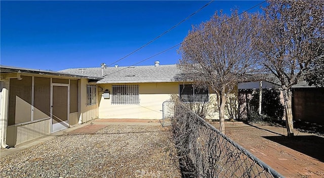 rear view of property featuring a patio area