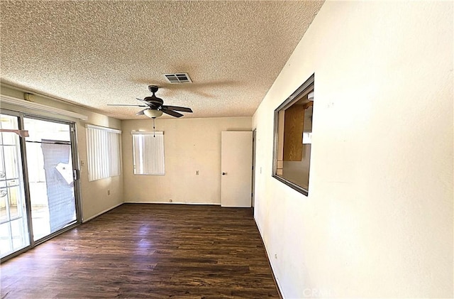 unfurnished room featuring a textured ceiling, ceiling fan, and dark hardwood / wood-style flooring