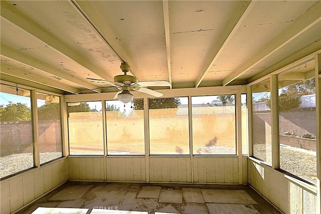 unfurnished sunroom with ceiling fan and plenty of natural light