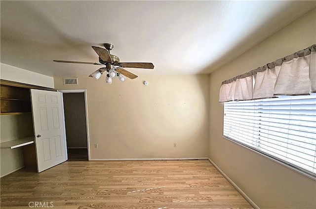 unfurnished bedroom with ceiling fan, a closet, and light hardwood / wood-style floors