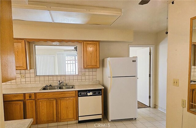 kitchen featuring decorative backsplash, sink, white appliances, and light tile patterned flooring