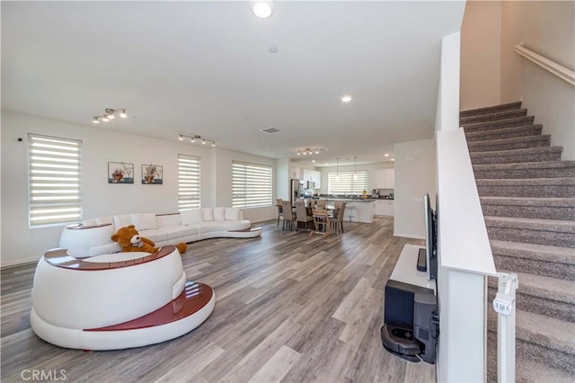 living room with a wealth of natural light and light hardwood / wood-style floors