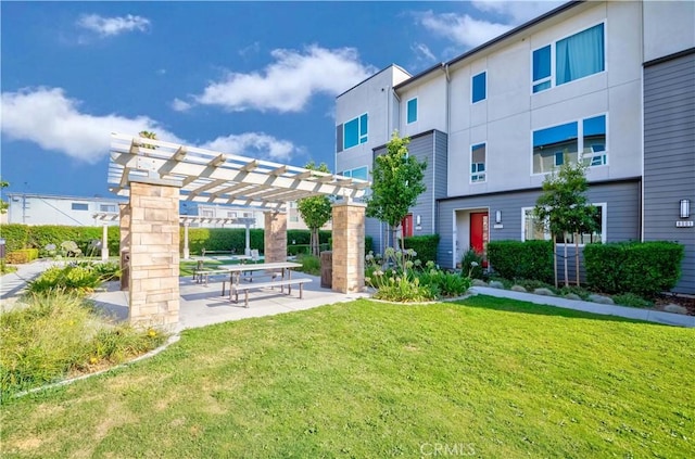 surrounding community featuring a yard, a patio, and a pergola