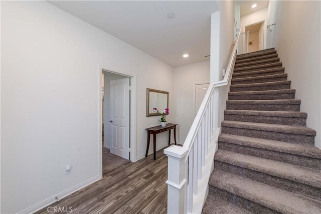 stairs with hardwood / wood-style floors